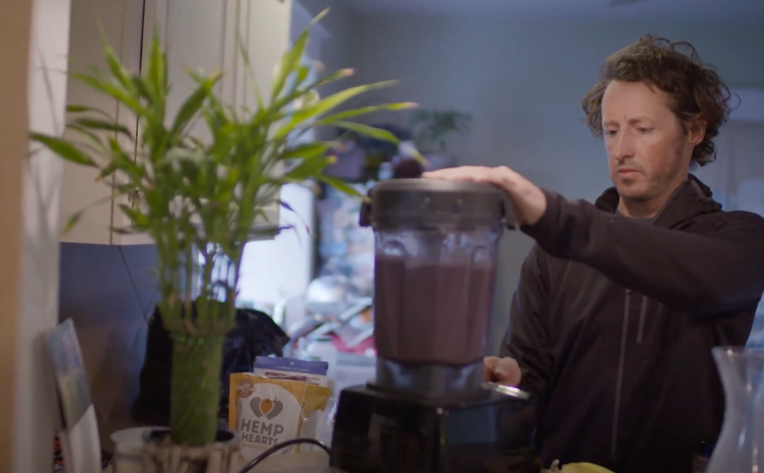 HANAH Hero Forrest Shearer in the kitchen blending together his smoothie bowl with HANAH ONE.